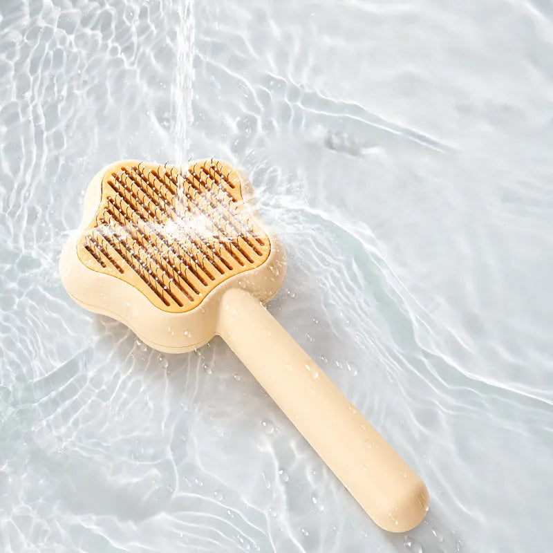 Self-cleaning stainless steel cat comb magic wand measuring 20cm with green or yellow colour options