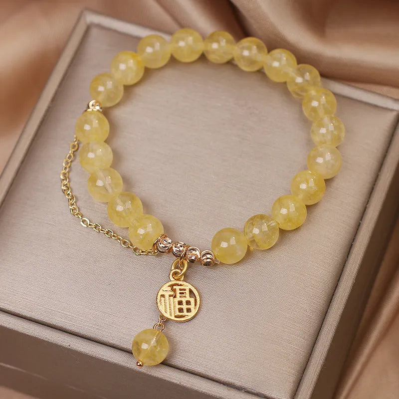Natural citrine bracelet with gold electroplated Chinese character charm on adjustable tassel