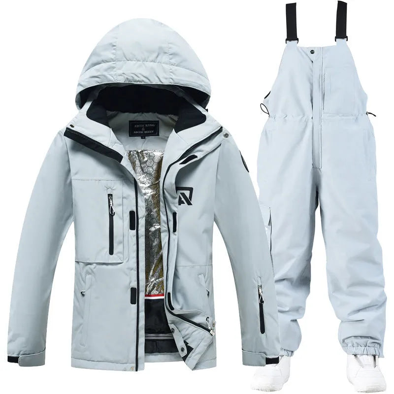 Men's and women's waterproof winter ski suit in blue top with grey blue trousers.