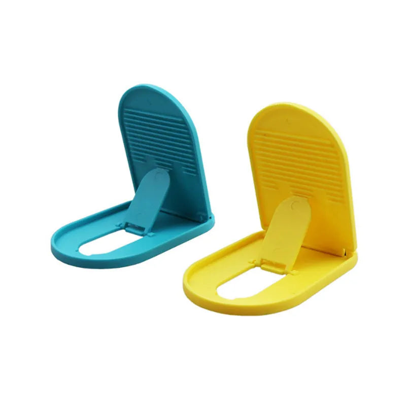 Plastic lazy bracket mobile phone stand in multiple colours on a desk