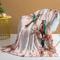 Pink hummingbird floral flannel velvet fleece throw blanket on sofa