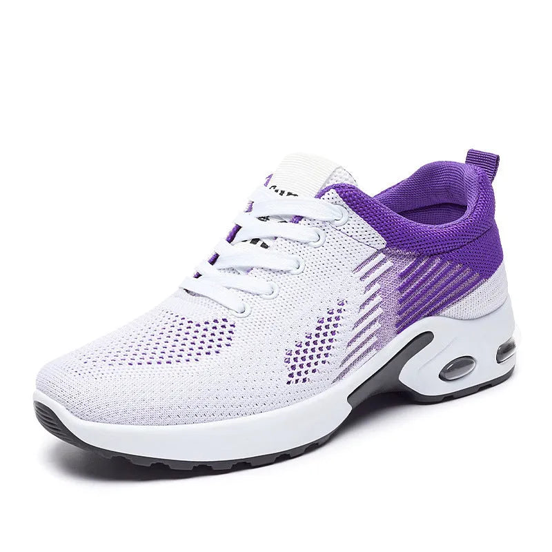 Women's Flyknit casual running shoes in pink with lace-up front and flat PVC sole.