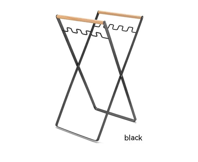 Black folding wrought iron rubbish storage hanger with wooden handle for outdoor use