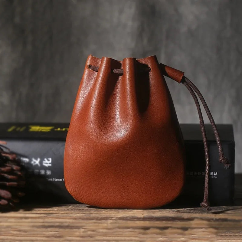 Vintage cowhide drawstring bundle wallet in chocolate brown showing sewing thread detail.