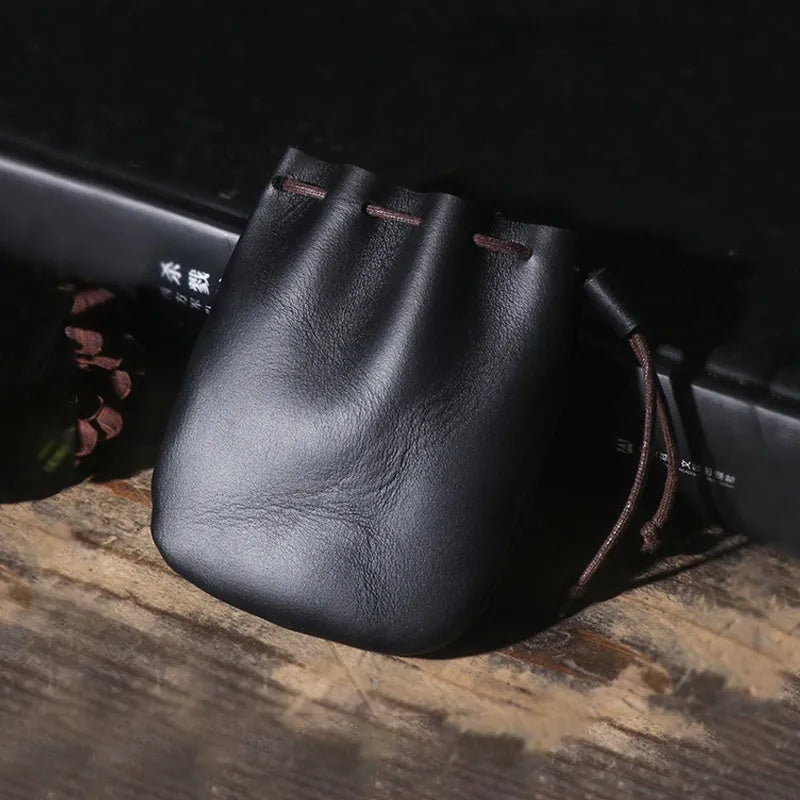 Vintage cowhide drawstring bundle wallet in chocolate brown showing sewing thread detail.