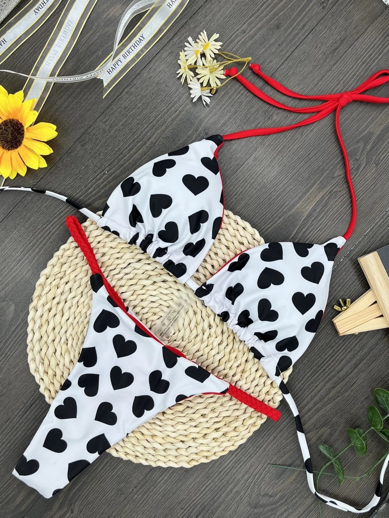 Heart print backless two-piece swimsuit with high-cut legs and split sides on a mannequin