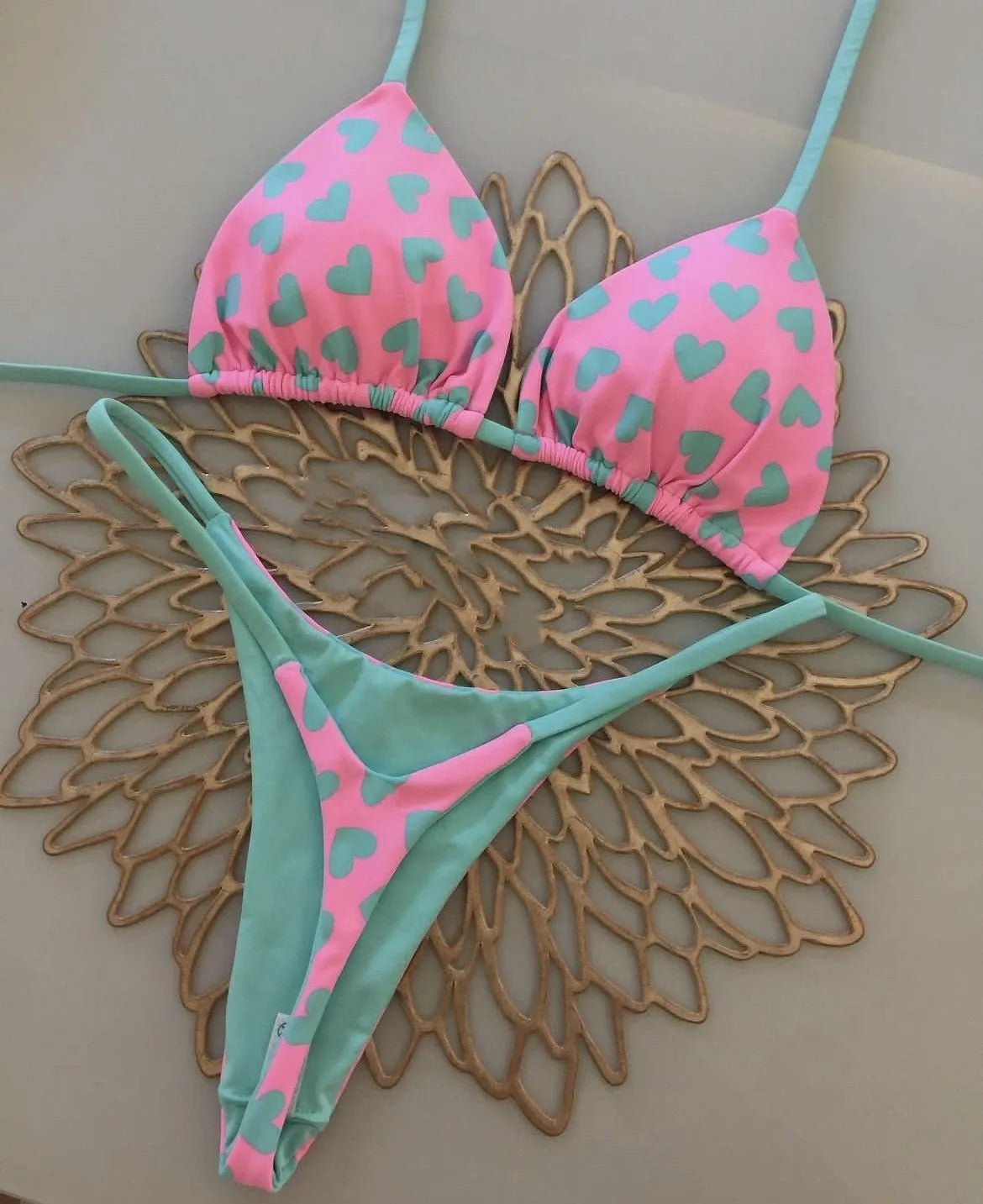 Heart print backless two-piece swimsuit with high-cut legs and split sides on a mannequin