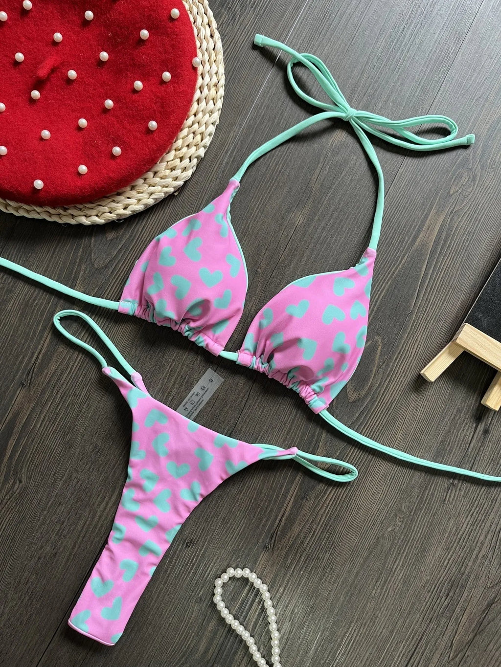 Heart print backless two-piece swimsuit with high-cut legs and split sides on a mannequin