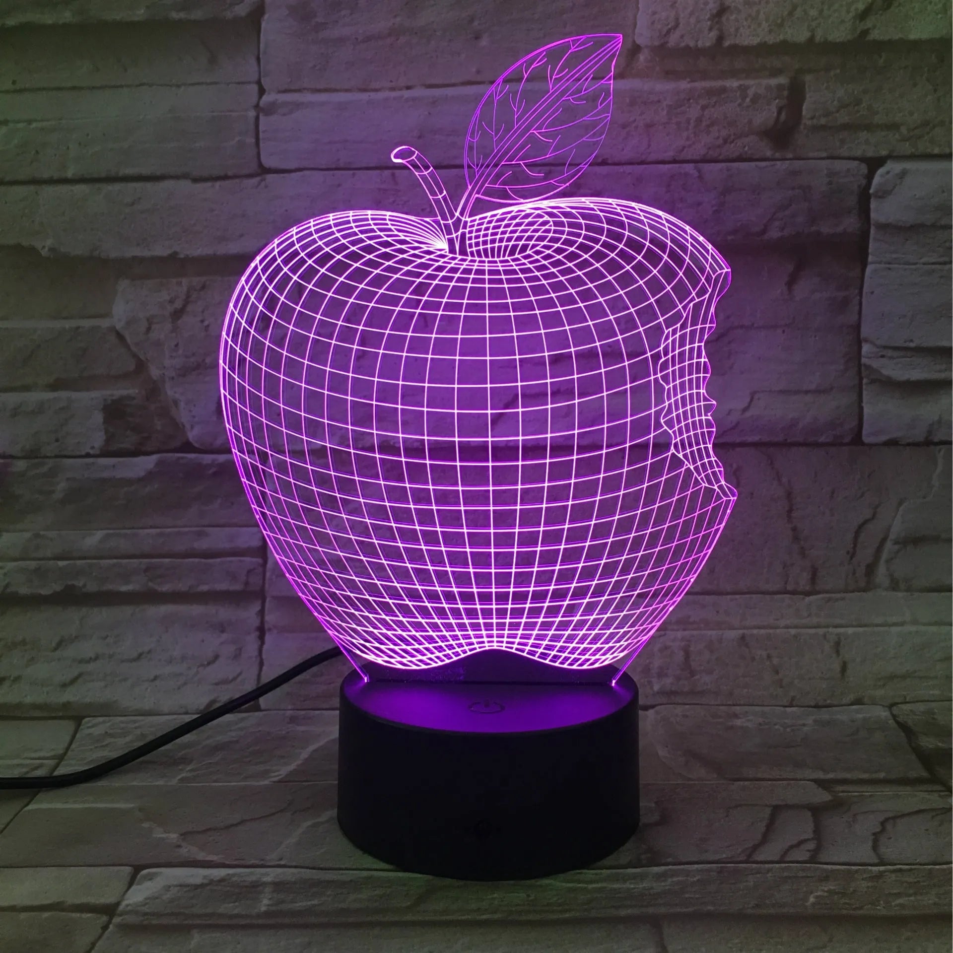 3D fruit-shaped colourful night light with touch controls and acrylic shade on a surface.