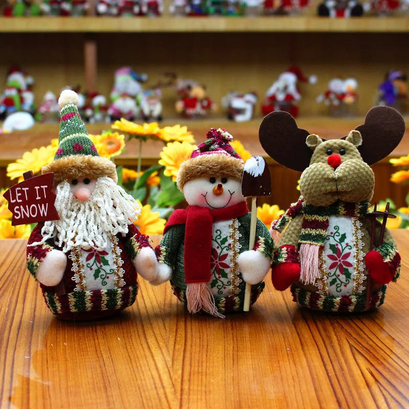 Three flannel Christmas snowman decorations in red, green and white colours