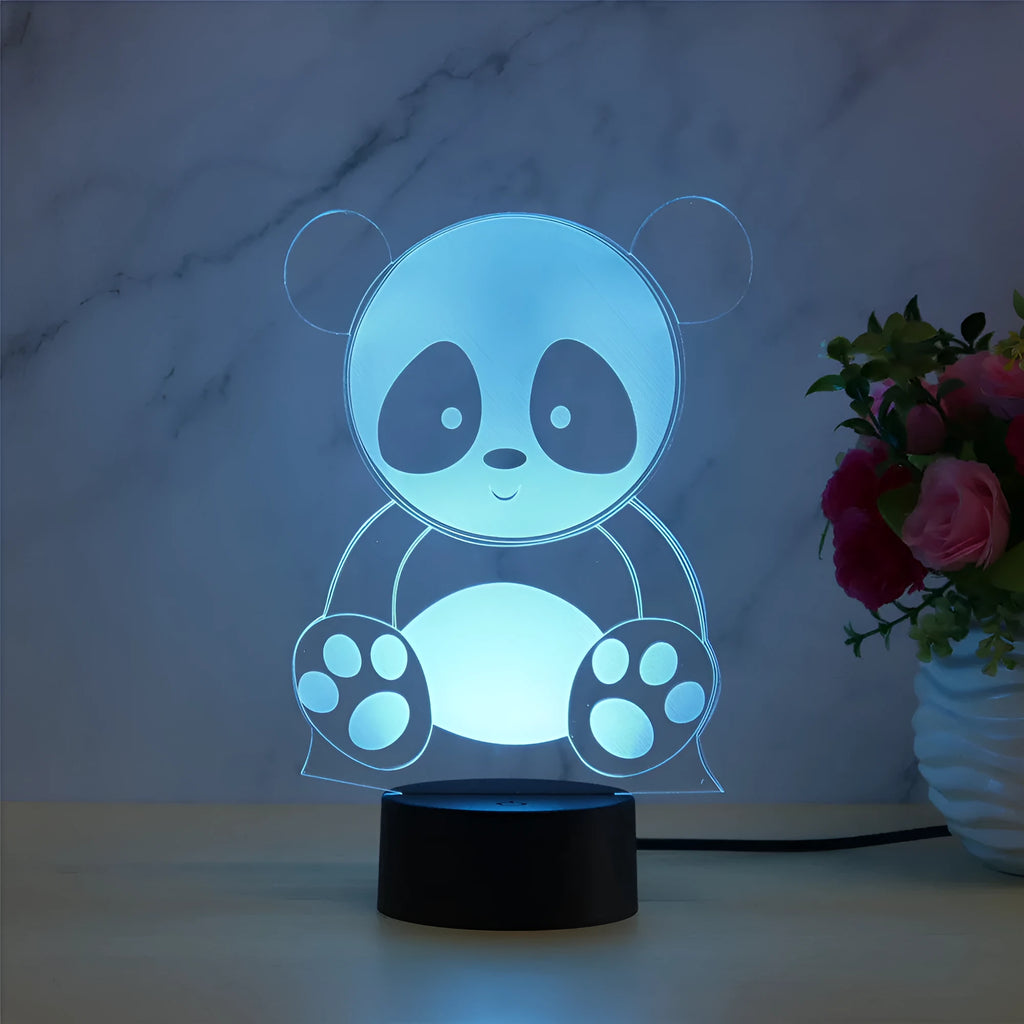 Panda-shaped acrylic night light with remote control displaying multiple colours on a black ABS base.