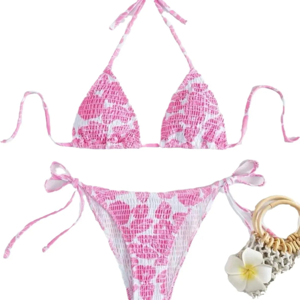 Women's floral print halter neck swimsuit briefs in light blue on a mannequin.