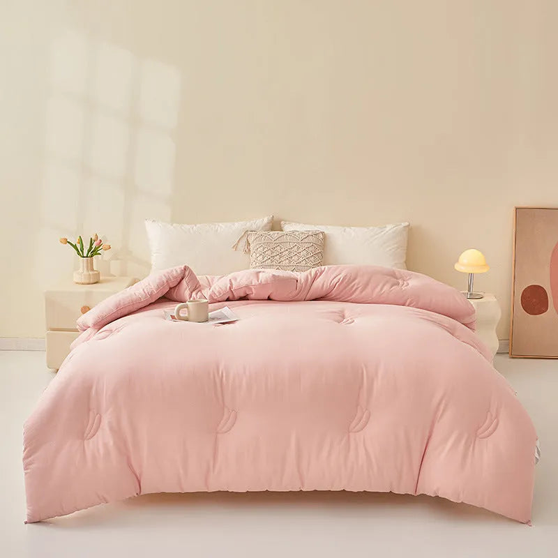 Soybean fibre quilt with pure cotton cover in grey colour on a bed.