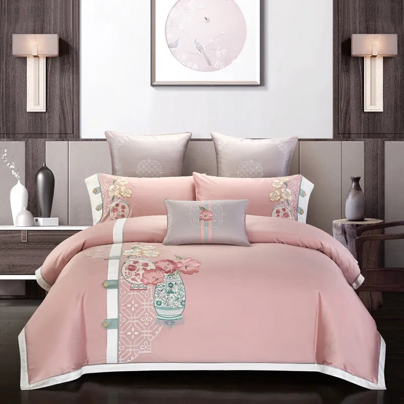 A four-piece cotton bedding set with embroidery, shown in one of five available designs.