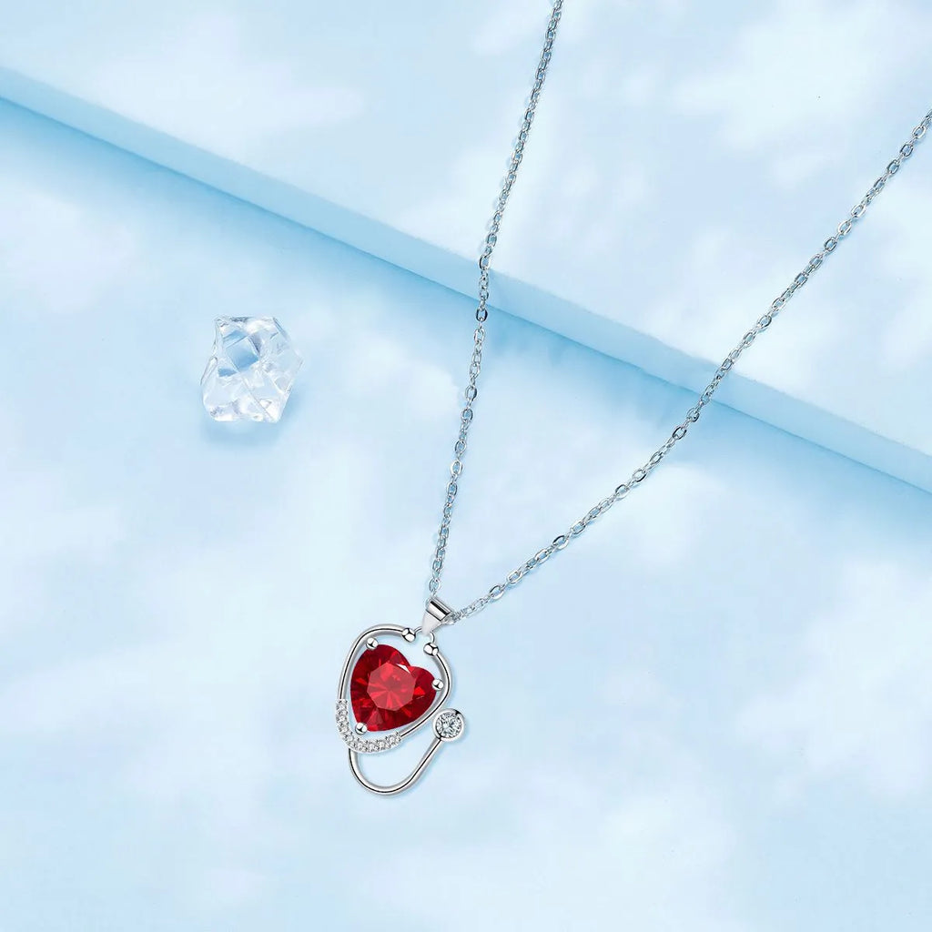 Women's fashion necklace with stethoscope and wing design in red diamond electroplated finish on copper