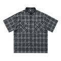 Men's black and brown plaid short sleeve shirt with embroidered letter design and lapel collar.