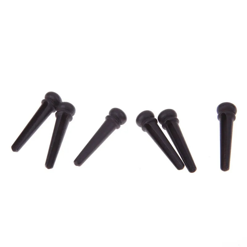 Six black matt ebony guitar bridge pins with solid string cone design