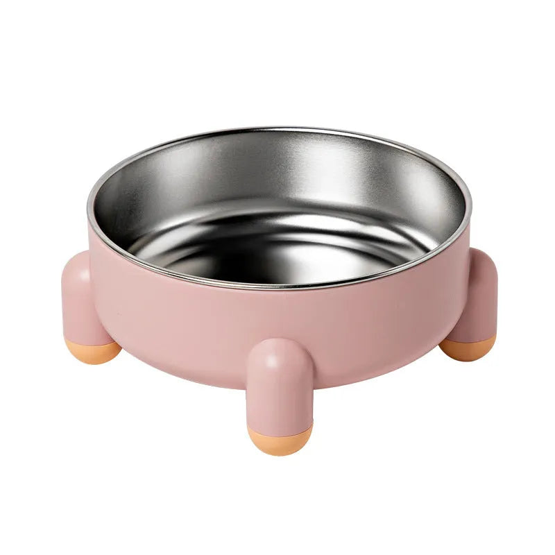 Green stainless steel pet bowl with a high foot and non-slip base on a kitchen floor.