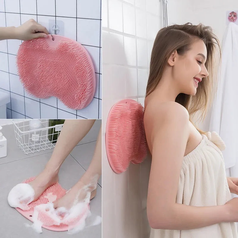 Orange silicone bristle bath brush with suction cup base on a bathroom floor.