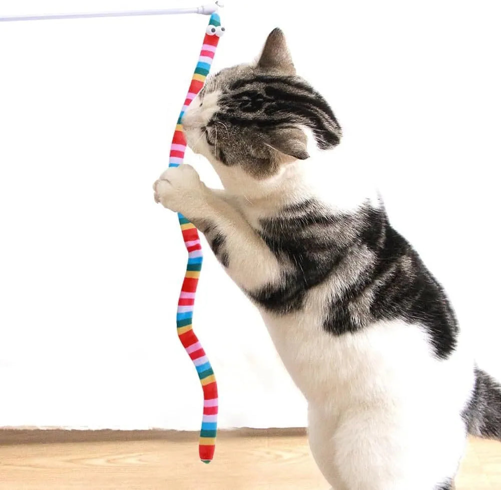 Colourful cat teaser wand with a long plush strip and a bell, held by a person.