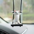Resin cartoon cat pendant for car interior decoration on adjustable rope.