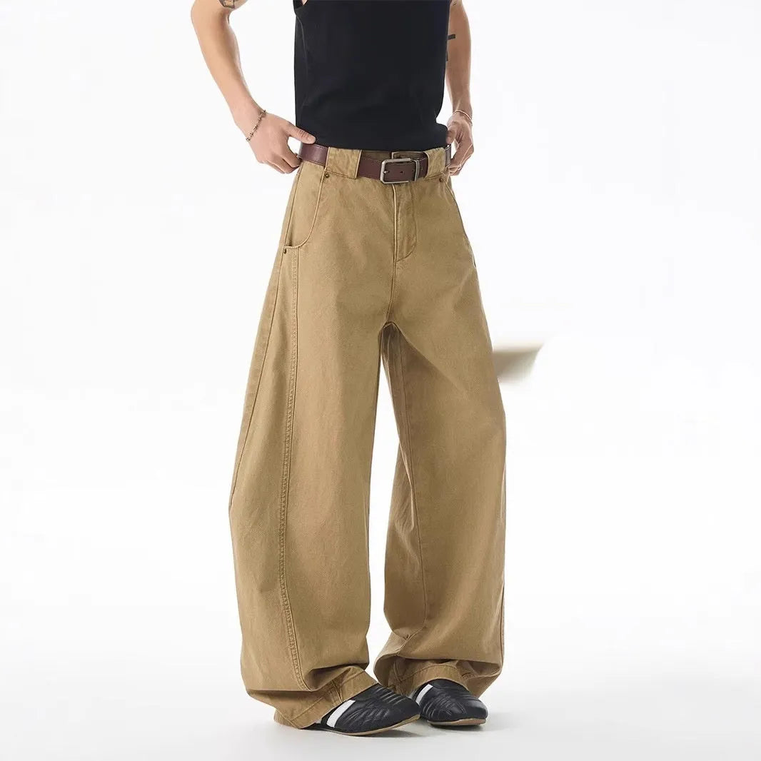 Brown men's loose fit straight leg jeans with a button fly on a mannequin.