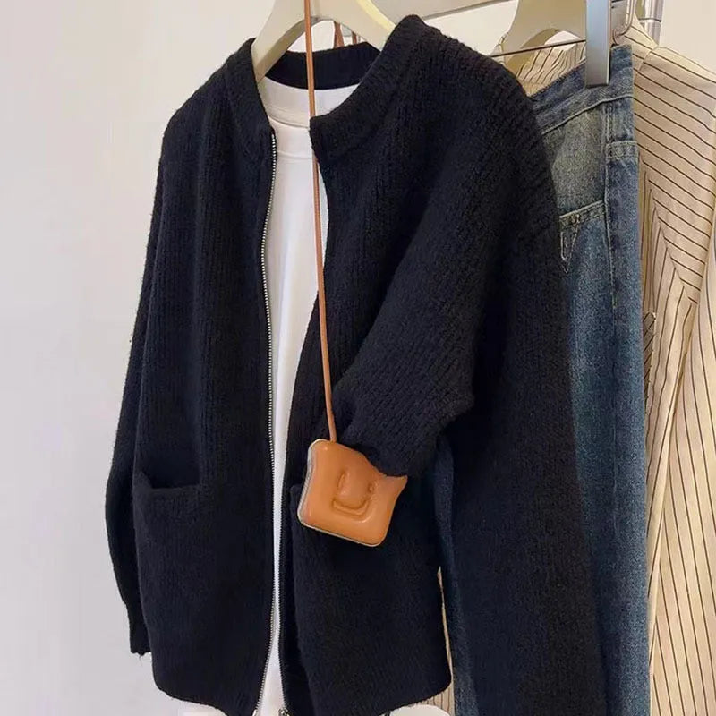 Beige viscose knit long sleeve cardigan sweater coat on a hanger