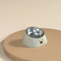 Green elevated pet feeding bowl with tilted stainless steel insert and wide anti-slip base.