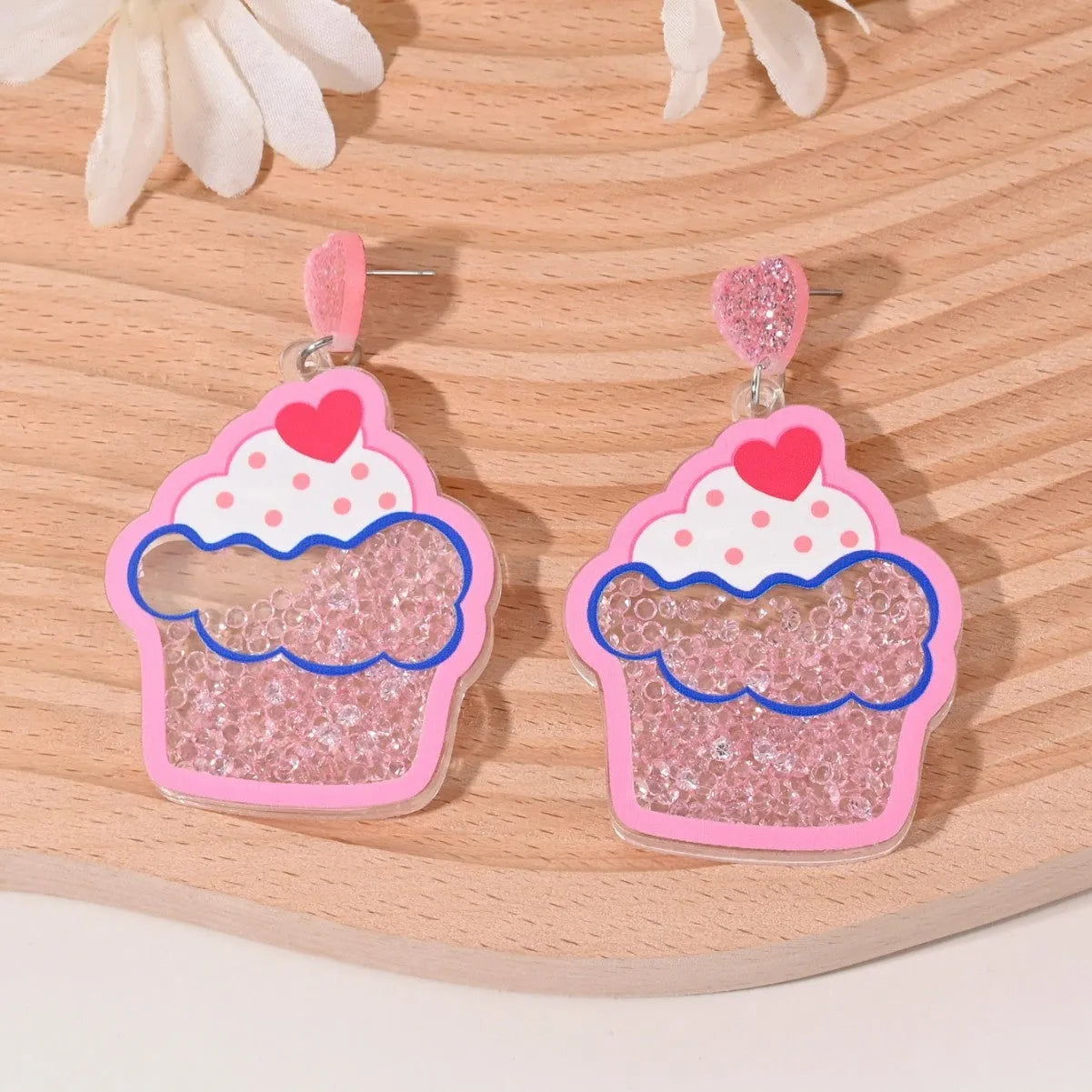 Colourful acrylic fruit and ice cream dangle earrings for women on a white background.