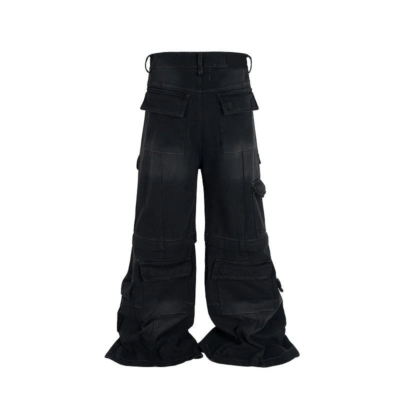 Black washed-out cotton overalls with multiple pockets and a detachable micro-pull design on a hanger.