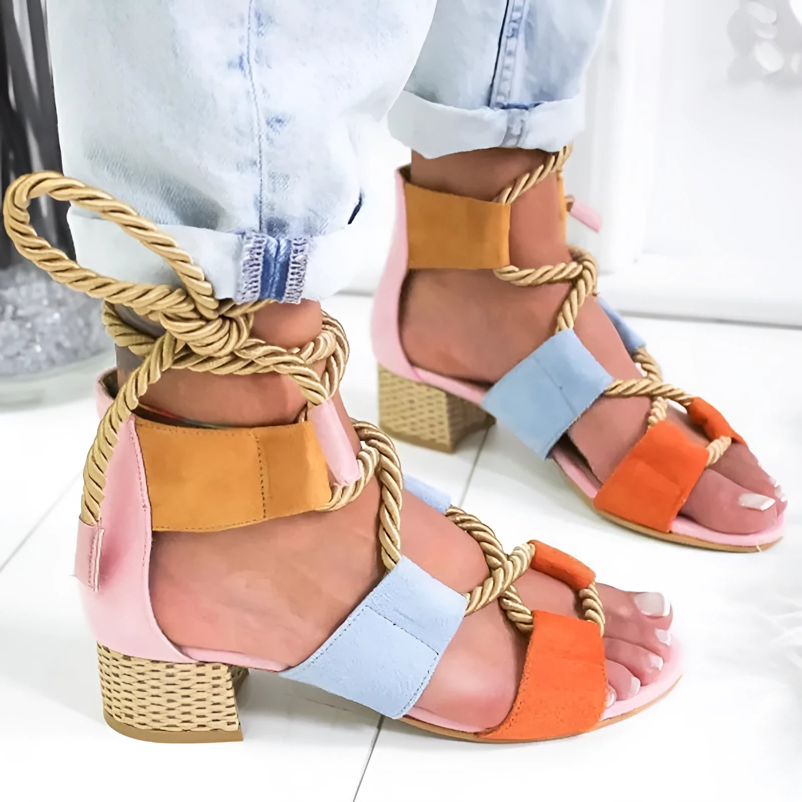 Women's beige suede sandals with fish-mouth toe, colour-matched pattern, and ankle strap on a thick heel.