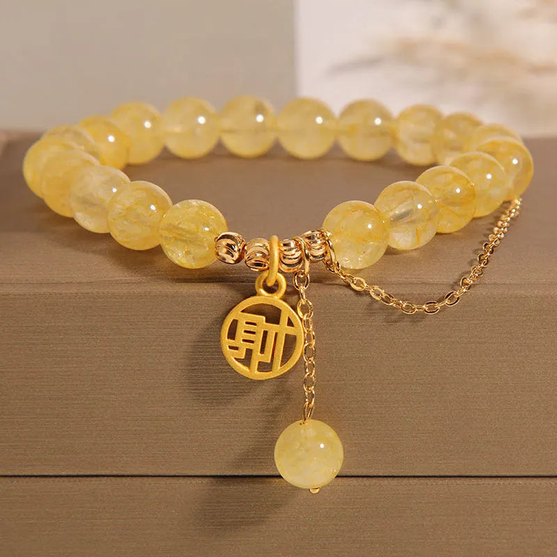 Natural citrine bracelet with gold electroplated Chinese character charm on adjustable tassel