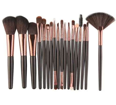 18-piece makeup brush set with fan brushes arranged on a table.