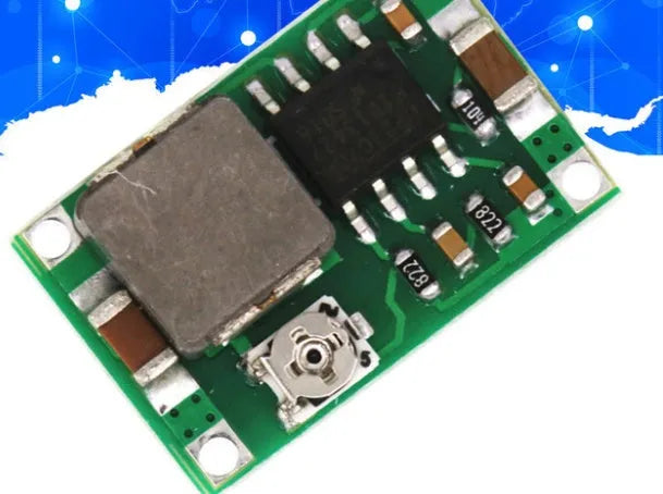 Mini-360 green DC-DC buck converter step down power supply module on white background