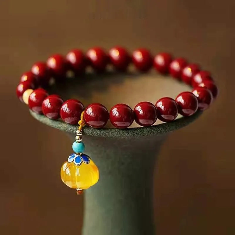 Gold cinnabar and copper wave bracelet in pumpkin or brand colour on wrist.