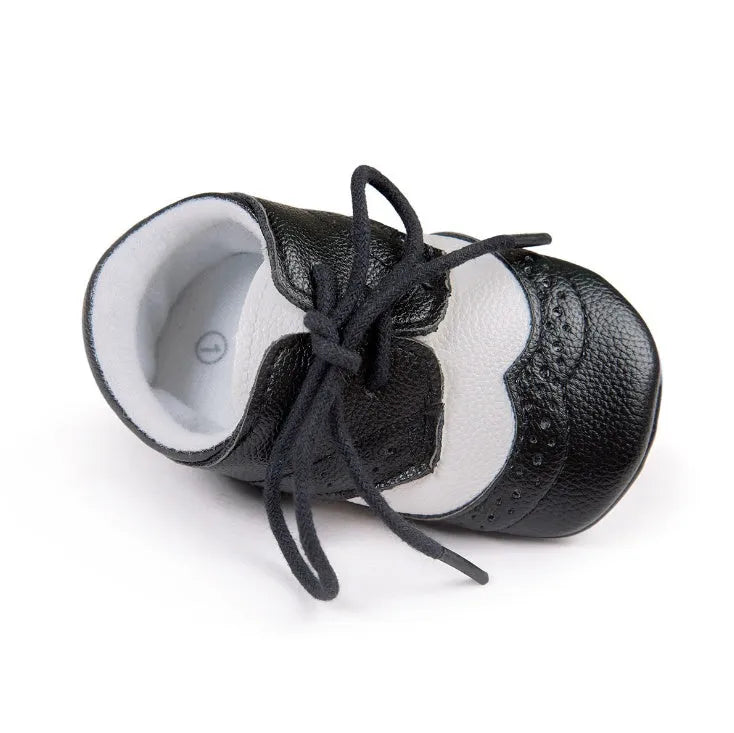 Vintage style soft-soled baby shoes for boys in synthetic leather, available in black, grey, light brown, and white.