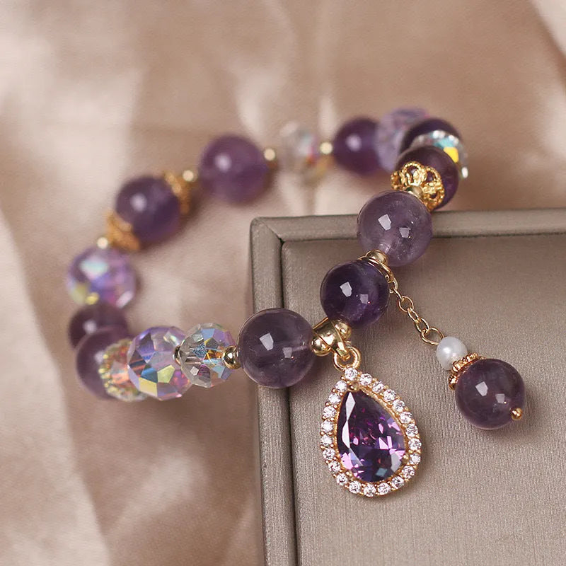 Close-up of a women's purple amethyst crystal bracelet with detailed micro inlay stone setting.