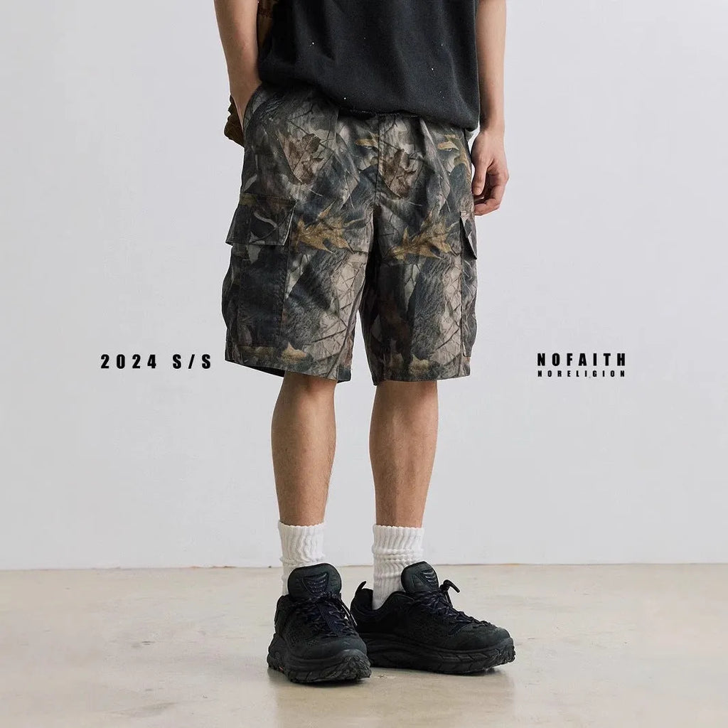 Loose straight-leg denim shorts in army green with a zip fly and elasticated mid-waist.