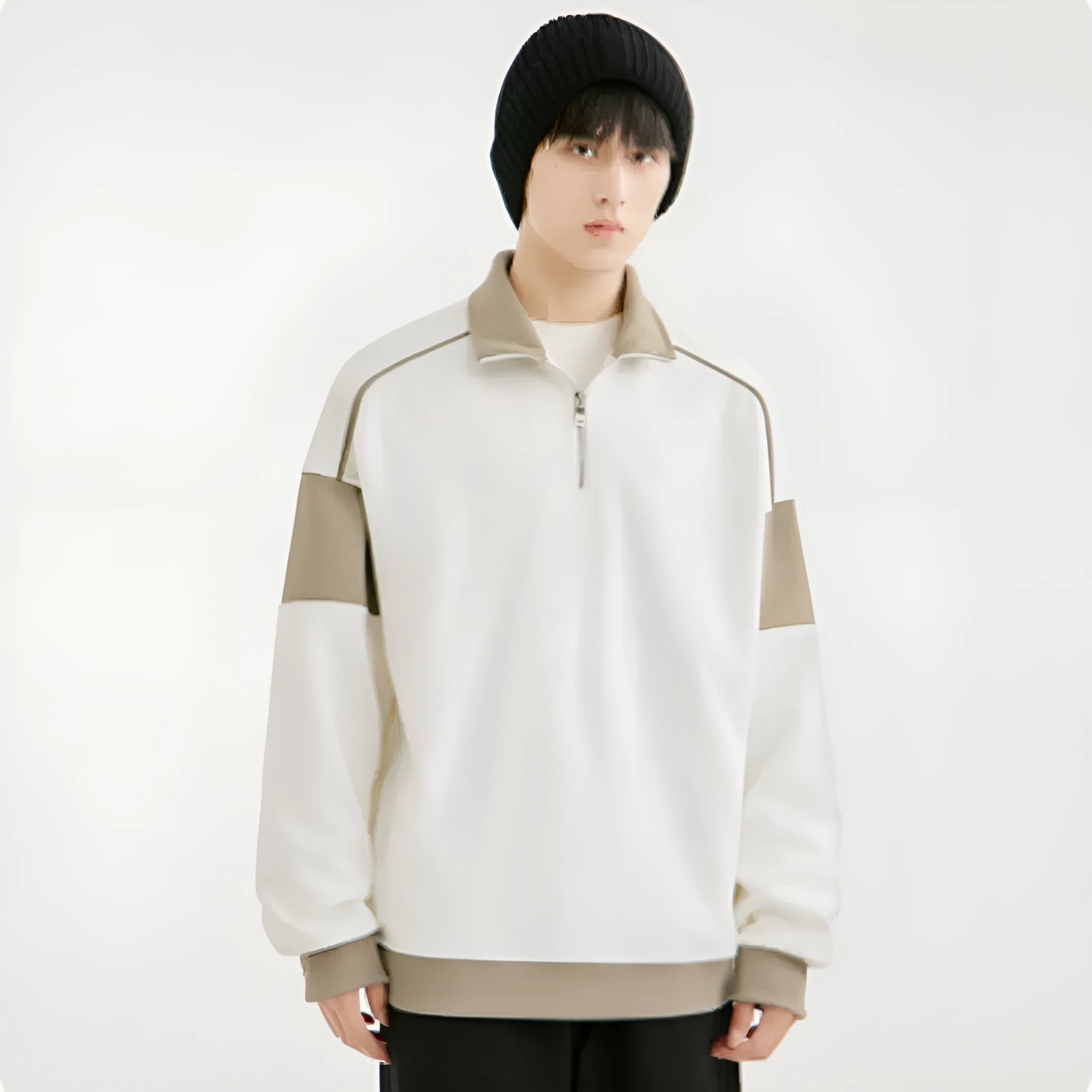 Man wearing a beige corduroy drop shoulder hoodie with loose lapels.