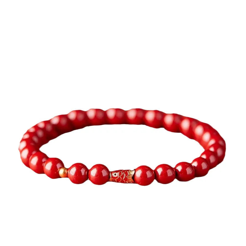 Natural cinnabar koi bracelet with golden ball charm in traditional Chinese style design