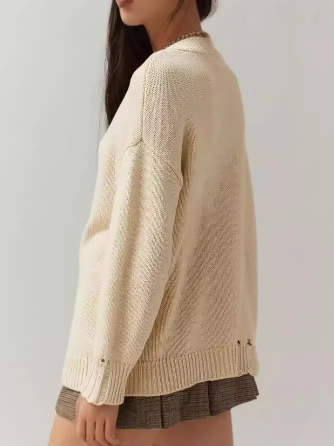 Beige women's loose-fitting acrylic jacquard pullover sweater with round neck and long sleeves.