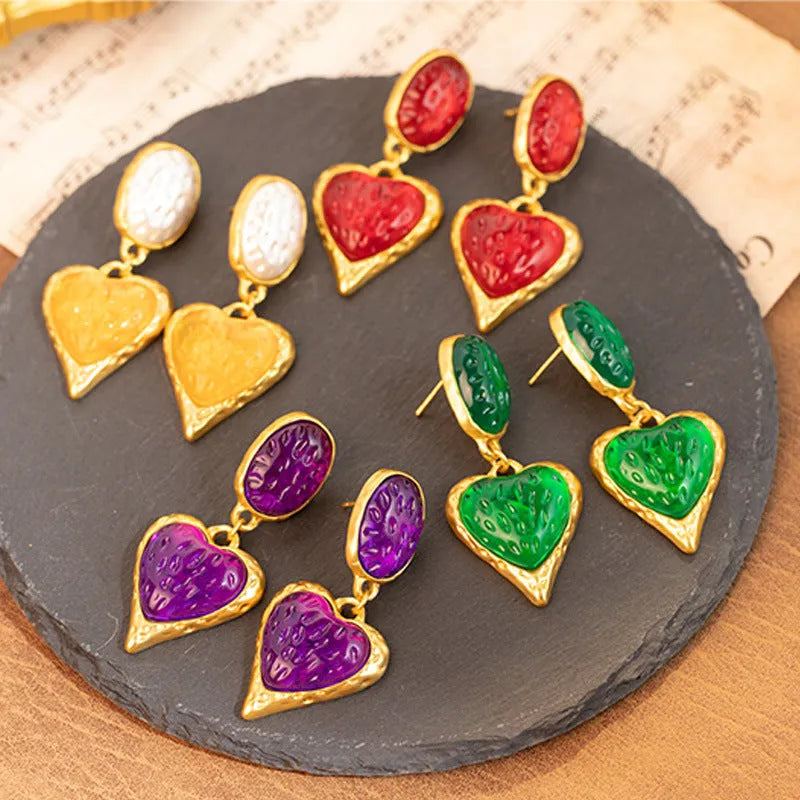 Pleated oval heart stud earrings in alloy showing four colour options