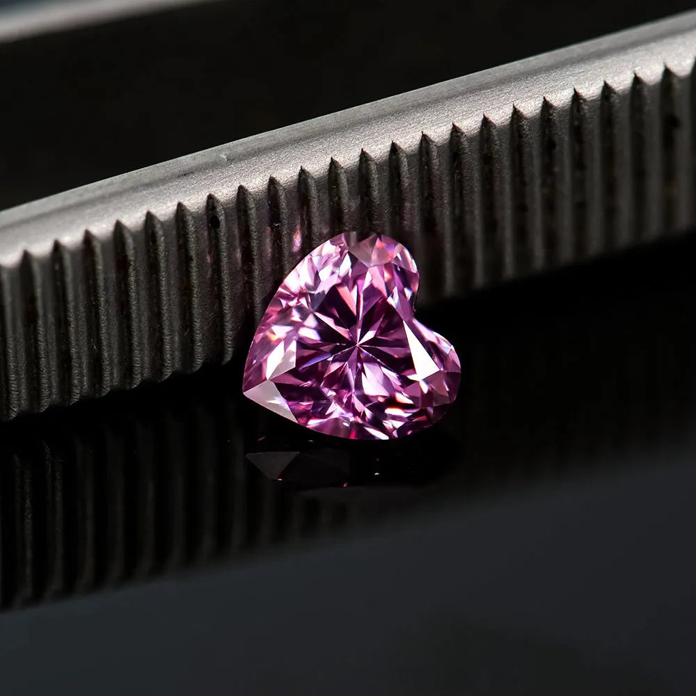 Loose lemon yellow heart-shaped moissanite stone on a plain background showing its size and cut.