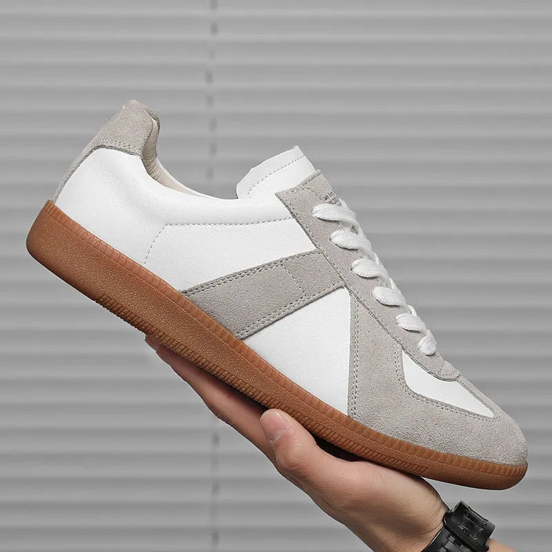 White Japanese-inspired retro unisex sneakers with low-top lace-up design on a rubber sole