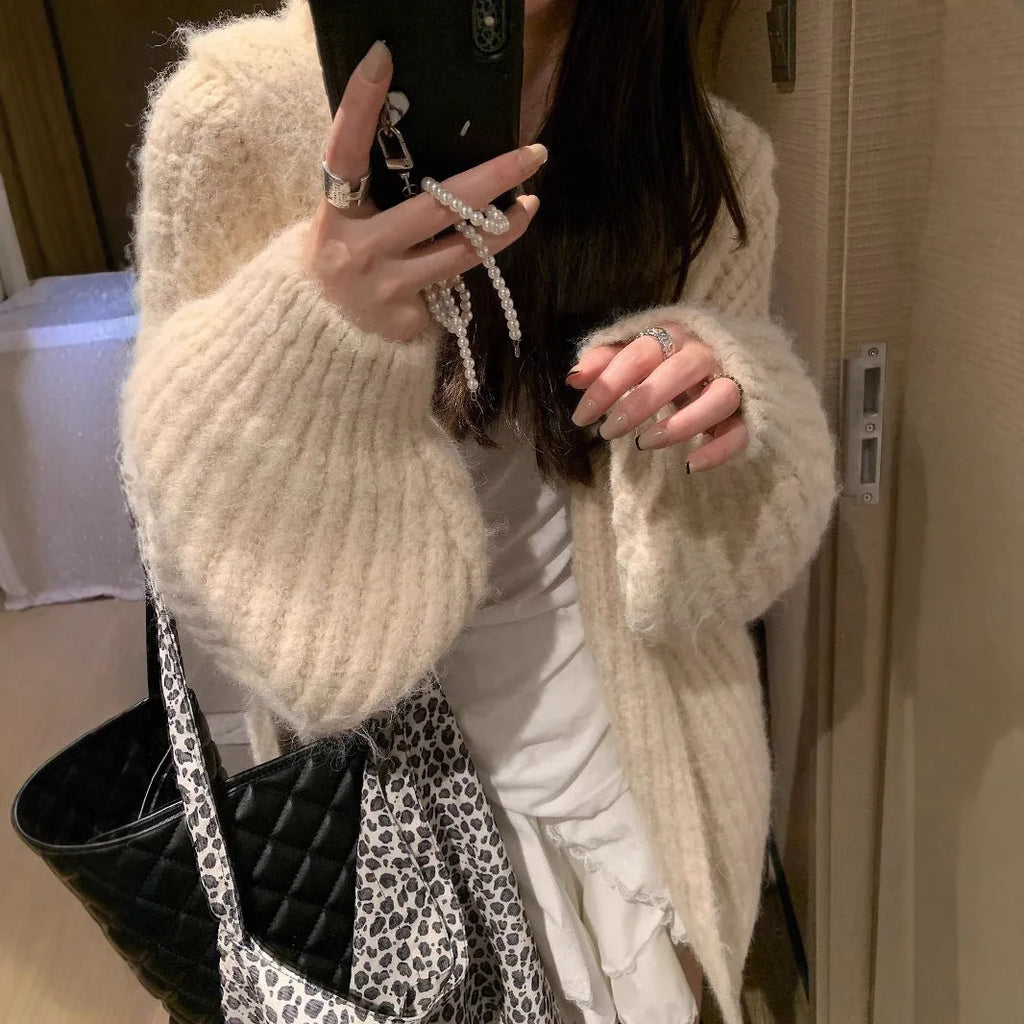 Women's loose hooded cardigan in thick acrylic blend, shown in dark grey, brown, and milky white.