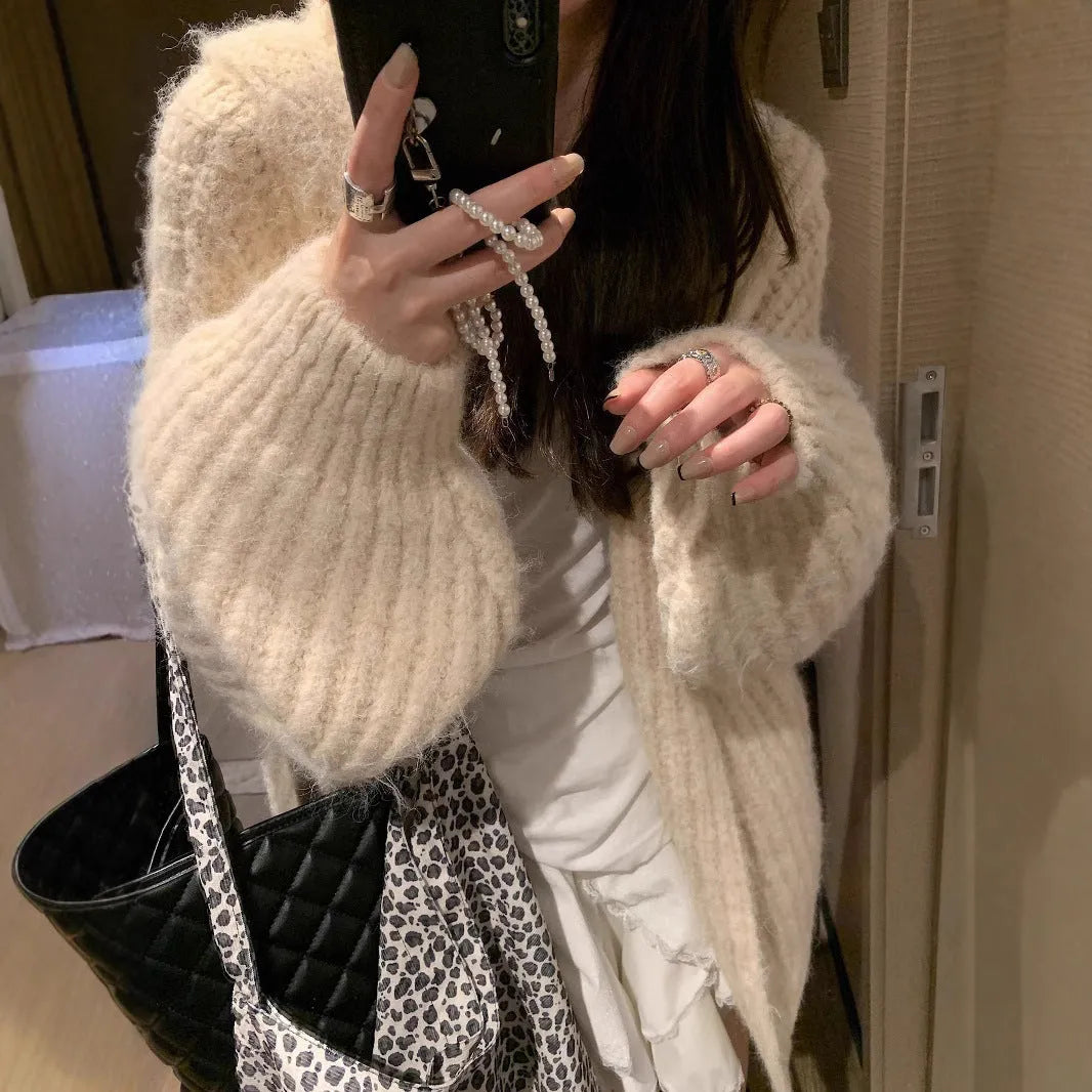Women's loose hooded cardigan in thick acrylic blend, shown in dark grey, brown, and milky white.