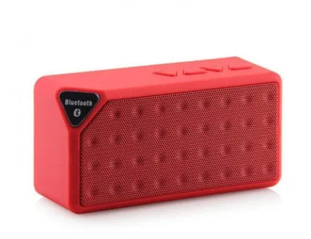 Cannon X3 small cube-shaped portable Bluetooth speaker in multiple colours on a table