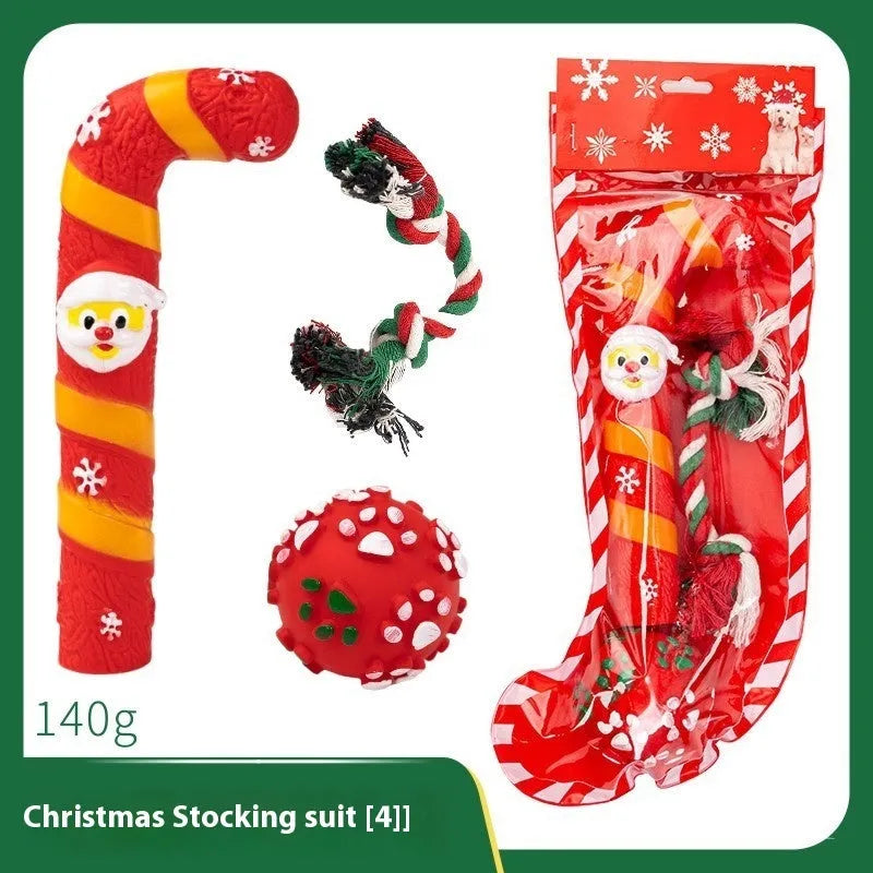 Seven Christmas gift bags containing vinyl dog toys with Santa heads, trees and deer figures