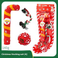 Seven Christmas gift bags containing vinyl dog toys with Santa heads, trees and deer figures