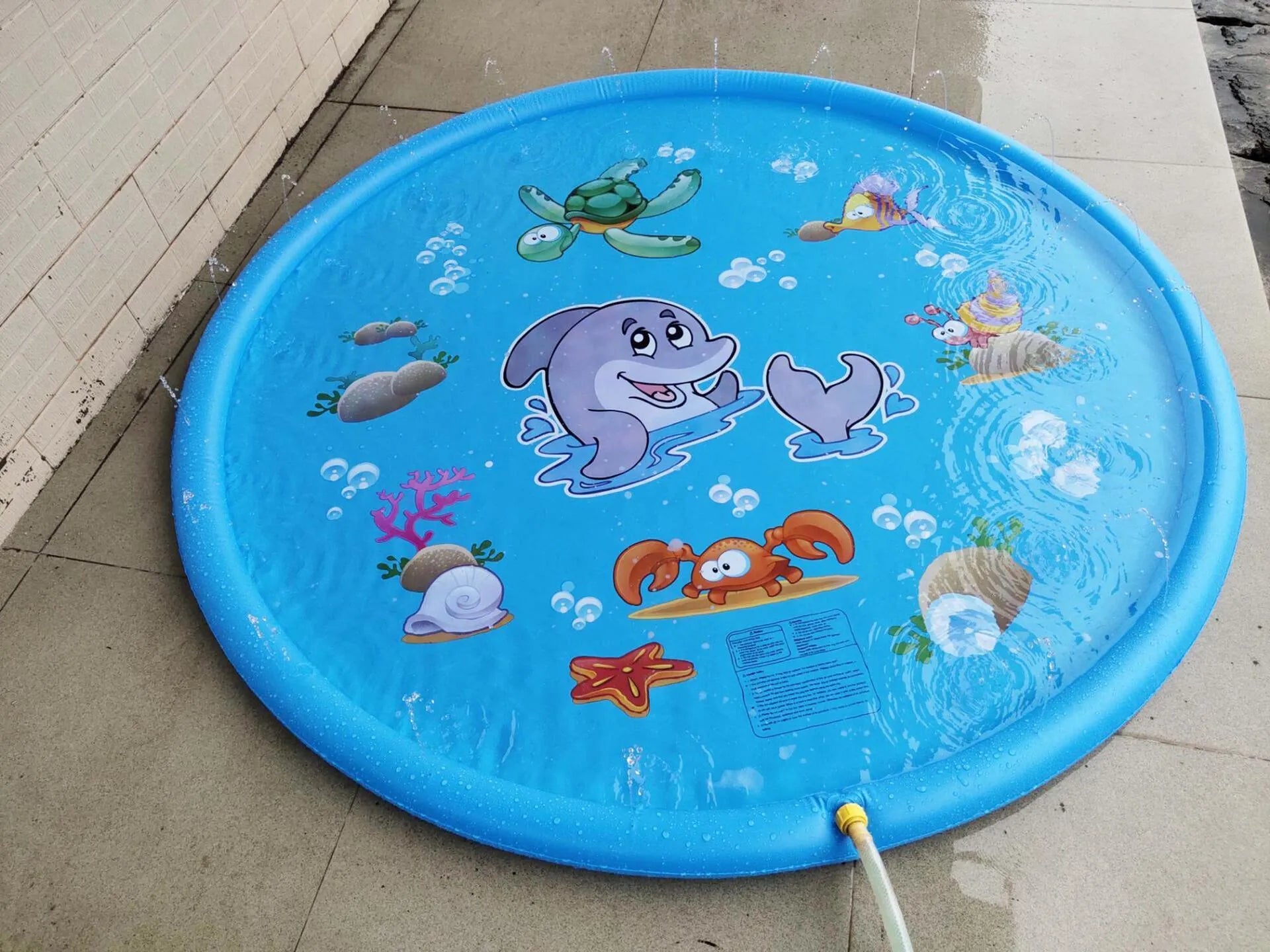 Children's water spray play mat with marine animal designs for outdoor garden use